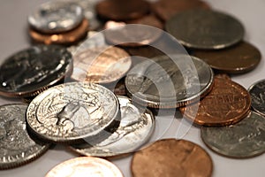 Pocket change scattered around multiple coins