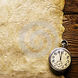 Pocket clock on old paper