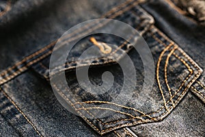 Pocket of denim jacket is gray in close-up. Advertising background of manufacturer of denim clothing.