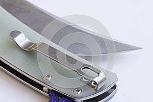 Pocket folding knife with stainless steel blade close-up. Hunting accessories. Photo mockup