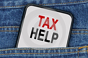 In a pocket of jeans there is a smartphone on the screen of which the text - TAX HELP