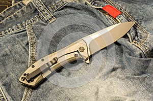 Pocket knife. The reverse side of the knife. View from above. Warm mood.