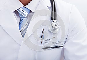 Pocket on a lab coat with a doctors id tag and pen