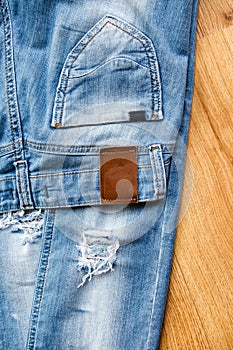 Pocket and label of ripped jeans