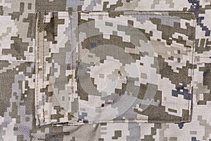Pocket on pants of pixellated digital camouflage fabric close-up photo