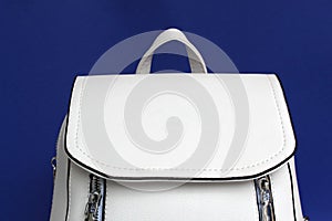 White bag backpack on a blue background photo