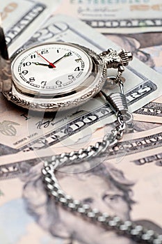 A pocket watch on American currency