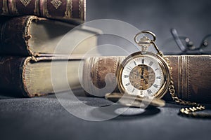 Pocket watch and books in library or study