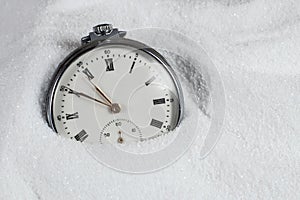 Pocket watch buried in sand. Old watch lost in the sand
