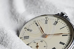 Pocket watch buried in sand. Old watch lost in the sand