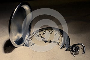 Pocket watch covered with sand