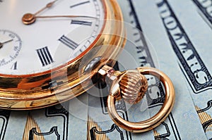 Pocket watch and dollars