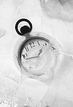 Pocket watch embedded in ice photo