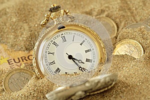 Pocket watch and euro money in the sand - The time value of money concept