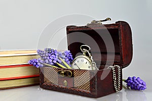 Pocket watch, flowers, books and treasure chest