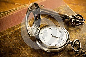 Pocket watch key and old book