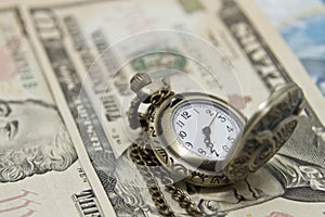 Pocket watch lie on dollars