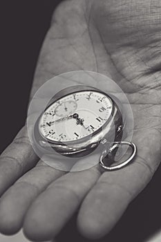 Pocket watch in a man`s hand, close-up, older person