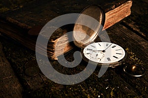 Pocket watch with an old antique bible book and ancient copper c