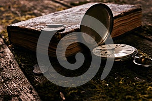 Pocket watch with an old antique bible book and ancient copper c