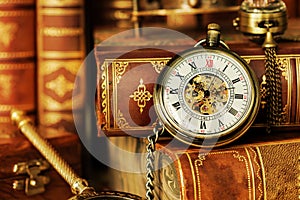 Pocket watch and old books