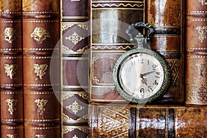 Pocket watch and old books