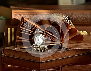 Pocket watch and old books