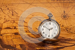 Pocket watch on old map background, vintage style