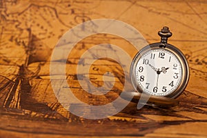 Pocket watch on old map background, vintage style