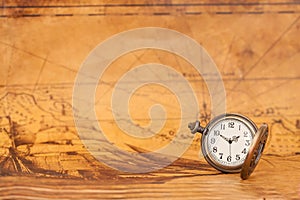 Pocket watch on old map background, vintage style