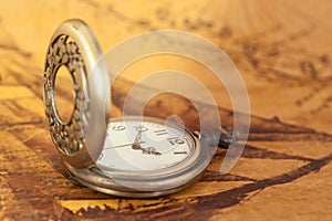 Pocket watch on old map background, vintage style