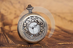 Pocket watch on old map background, vintage