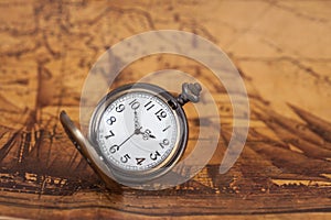 Pocket watch on old map background, vintage style