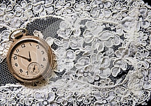 Pocket watch on white lace