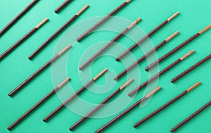Pocky candy pattern on green background, design for text. Horizontal format. Top view