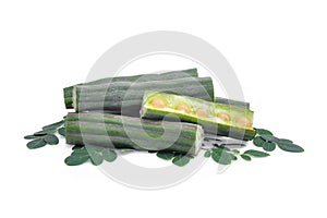 Pod of moringa drumstick tree with leaves isolated on white