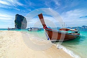 Poda Island Wooden boat parked on the sea, white beach on a clear blue sky, blue sea photo