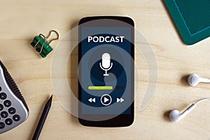 Podcast concept on smart phone screen on wooden desk photo