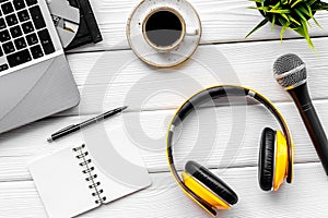 Podcast record with laptop, coffee, notebook, microphone and headphones on white background top view space for text