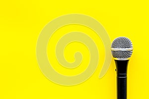 Podcast record with microphone on yellow background top view space for text