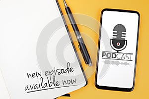 Podcasting concept, text NEW EPISODE AVAILABLE NOW written on note pad and smartphone with podcast player mockup photo