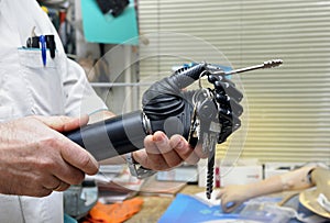 Podiatrist hands holding a new artificial limb with a keys clutched