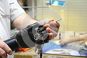 Podiatrist hands showing a new artificial limb with keys clutched