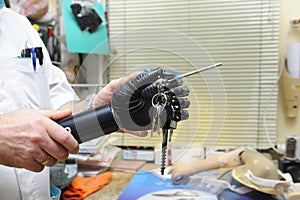 Podiatrist hands showing a new artificial limb with keys clutched