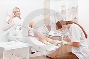 Podiatrist making procedure for client foot with special equipme