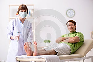 The podiatrist treating feet during procedure