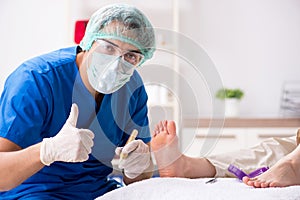 The podiatrist treating feet during procedure