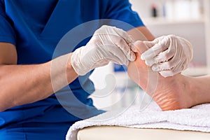 The podiatrist treating feet during procedure