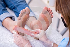 Podiatrist treating feet during procedure