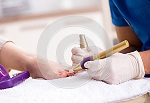 Podiatrist treating feet during procedure